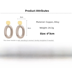 Detail view of large gold and transparent grey oval earrings with dimensions and weight