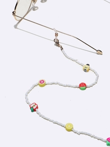 Colorful fruit bead glasses chain with white beads and diverse fruit charms on white background