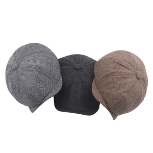 Detailed herringbone texture on light grey, charcoal, and coffee newsboy flat caps