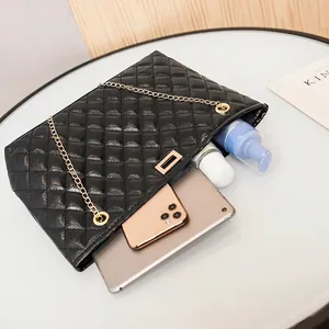 Elegant black quilted chain shoulder bag with large capacity showing interior storage space