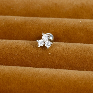 Macro shot of silver stainless steel helix stud with three round cubic zirconia stones