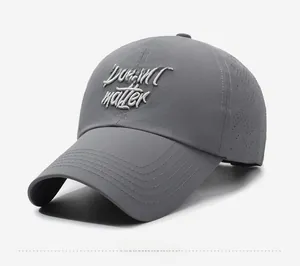 Detail of dark gray baseball cap featuring side laser-cut holes for enhanced breathability