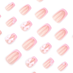 Sweet pink French press-on nails with 3D white bows and floral glitter accents