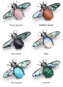 Detail showcasing bee-shaped brooches with abalone shell wings and various colorful gemstones