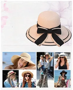 Detail of wide brim straw sun hat with black ribbon bow and elegant double trim accents