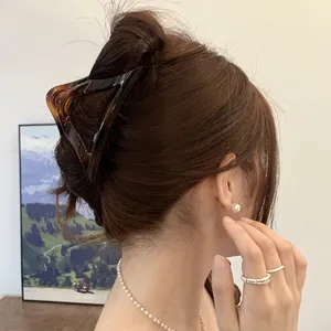 Tortoiseshell amber hair claw clip in triangular design for secure hold hairstyle