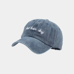 Close-up of vintage washed blue cotton baseball cap with bad hair day embroidery