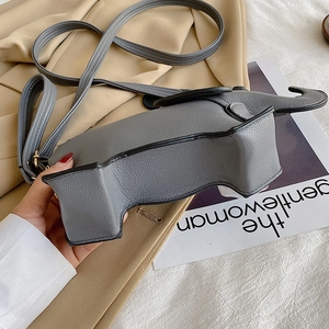Creative elephant-shaped grey PU leather crossbody bag on aesthetic magazine background
