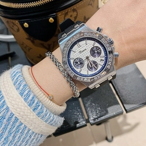 Detailed shot of silver bezel with crystals and black silicone strap on woman's wrist