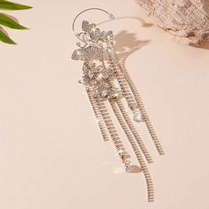 Macro shot of silver butterfly ear cuff featuring sparkling rhinestone fringe and tassels