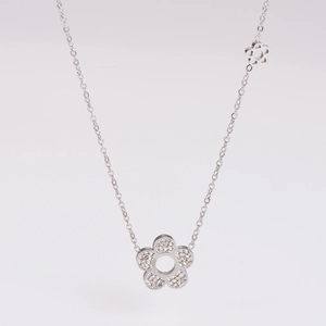 Detail shot of silver flower necklace with white zircon pavé and hollow floral charms