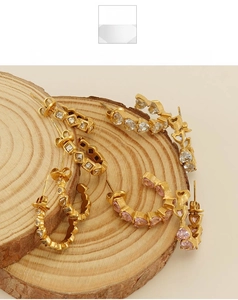 Detailed shot of 18k gold plated hoop earrings with heart and square zirconia stones