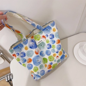 Detail of colorful fruit print cotton tote bag with a woven simple wish label