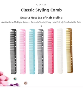 Detail view of seven colorful professional hair styling combs with hollow round holes