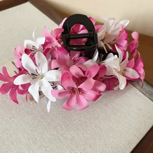 Pince à cheveux fleurie en tissu rose et blanc avec de grands pétales en soie élégants