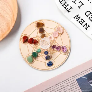 Natural chakra crystal set with polished gemstones on a sacred geometry wooden tray