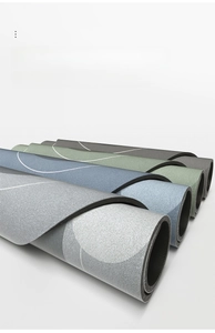 Detail of rolled quick-dry bath mats with smooth edges and modern abstract patterns