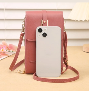 Detail of pink lychee leather crossbody phone bag with zipper and adjustable strap