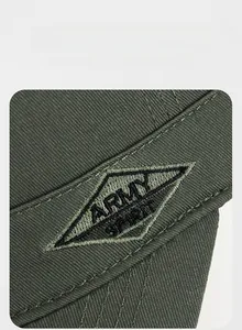 Detail of Army Spirit embroidery patch on olive green twill fabric of military cap