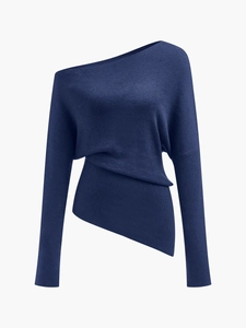 Detail of navy blue knit fabric on an asymmetrical off-shoulder long sleeve sweater
