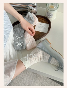 Detail of balletcore crew socks with side bows and pointelle knit pattern