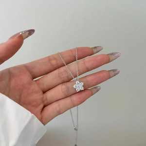 Close-up of S925 silver necklace featuring a sparkling five-petal flower zircon pendant