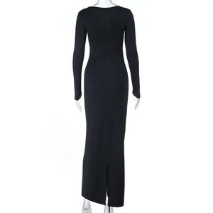 Detail view of the elegant black bodycon dress back slit and ruffled hemline
