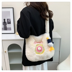 Close-up of off-white plush shoulder bag with donut embroidery and cute bird keychain