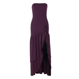 Detail of elegant fuchsia strapless maxi dress with ruffled slit and smooth fabric