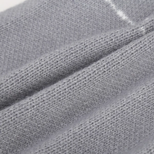 Close-up of grey knit beanie fabric showing white stripes and soft wool texture