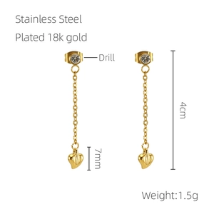 Detail of 18k gold plated stainless steel tassel earrings with heart pendants and crystals