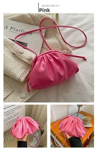 Detailed view of pink pleated PU leather dumpling bag with drawstring and thin shoulder strap