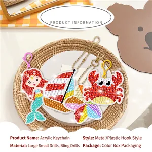 DIY diamond painting keychain set with mermaid and crab patterns in a woven tray