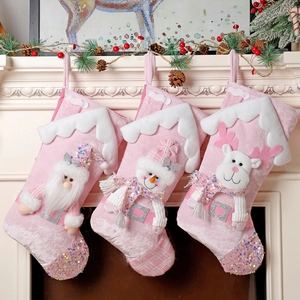 Three pink plush Christmas stockings with 3D Santa, Snowman, and Reindeer hanging decorations