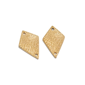 Macro view of gold rhombus pendants with unique cracked texture and dual connection holes