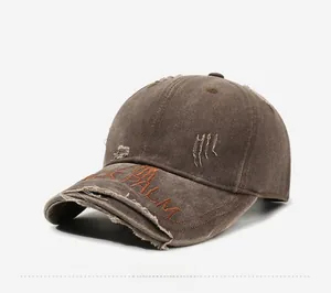Detail of PALM embroidery and distressed fabric on a vintage brown baseball cap