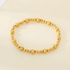 Detailed view of 18K gold-plated stainless steel bead bracelet with alternating size beads