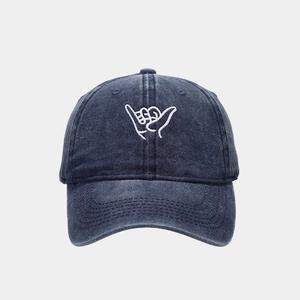Washed navy blue baseball cap with white Shaka hand embroidery and curved visor