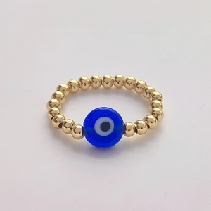 Detailed view of handmade 18K gold-plated beads with a blue glass Evil Eye charm ring