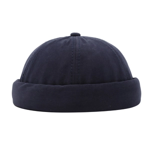 Minimalist navy blue cotton docker cap with retro brimless design and top button detail