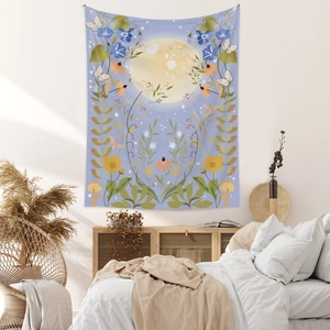 Detailed botanical scene with moon and flowers on a Bohemian tapestry hanging on a bedroom wall