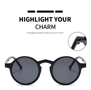 Detail view of round vintage punk sunglasses showing matte black frame and hinge mechanism