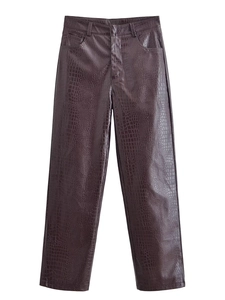 Detail of dark brown faux leather trousers with crocodile embossed texture and high waist