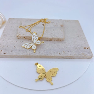 Detail of gold-plated white enamel butterfly pendant with micro-inlaid cubic zirconia