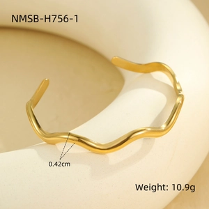 Detailed view of wave-textured golden open cuff bracelet showing width of 0.42cm and 10.9g