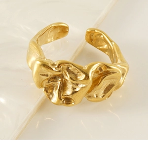 Detailed macro view of the 18K gold-plated irregular lava texture on an open ring