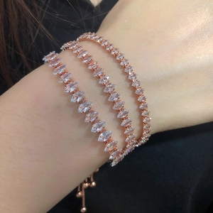Detailed view of three-piece marquise cut crystal tennis bracelets in rose gold finish