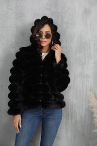 Detail of black hooded faux fur jacket featuring horizontal ribbing and metal zipper