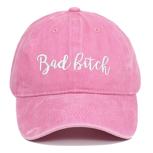 Detail of pink washed cotton baseball cap with white Bad Bitch script embroidery