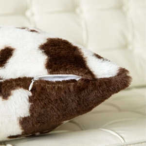 Brown and white cow print plush pillow cover with soft faux fur and hidden zipper